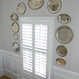 Silver trays on dining room wall